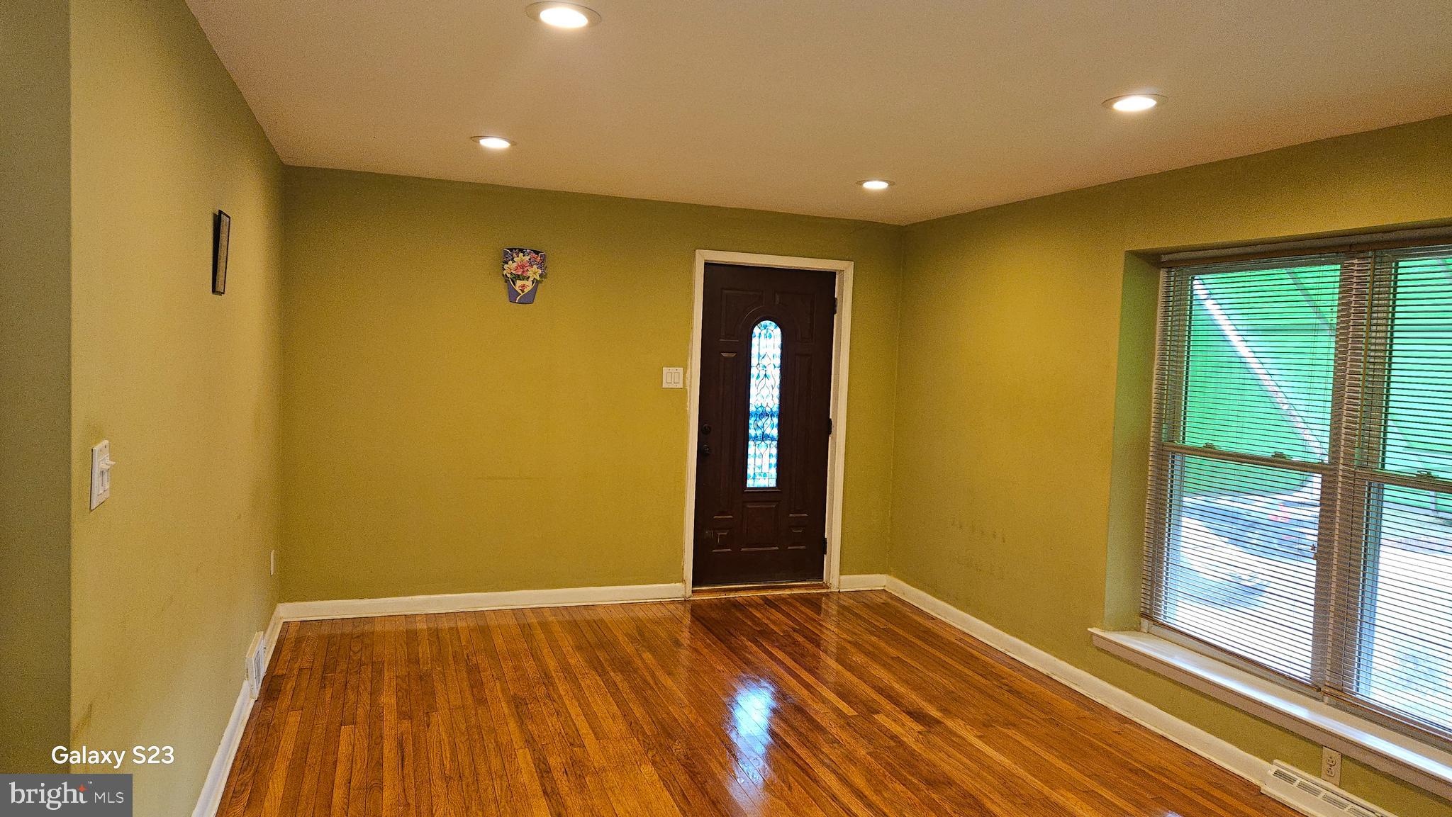 635 Colebrook Road Philadelphia, PA 19115 - Photo 27 of 31 a view of an empty room with wooden floor and a window