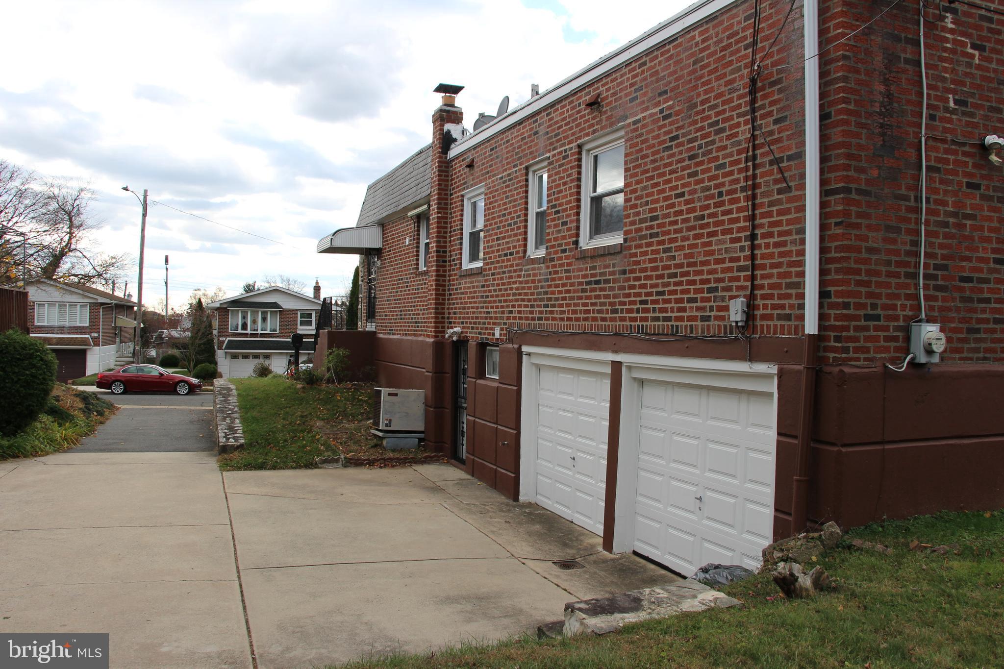 635 Colebrook Road Philadelphia, PA 19115 - Photo 4 of 31 a front view of a house with a garden