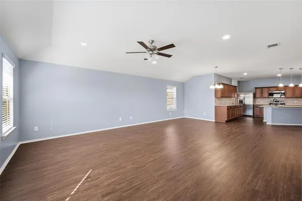 a view of a kitchen with a stove cabinets and wooden floor