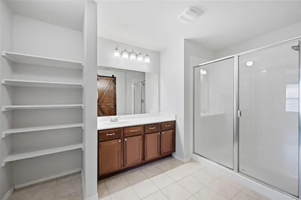 a spacious bathroom with a mirror and a shower