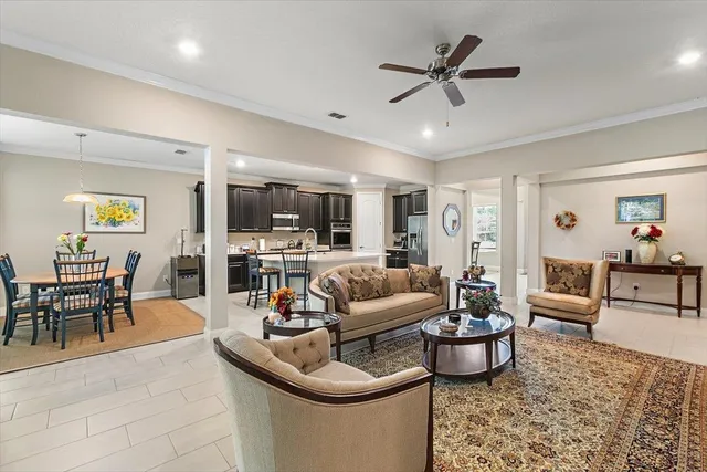 a living room with furniture a window and a flat screen tv