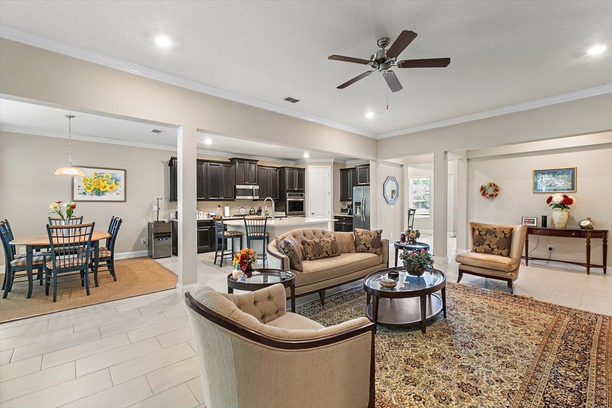 2996 Las Calinas Boulevard St. Augustine, FL 32095 - Photo 13 of 31 a living room with furniture kitchen view and a chandelier