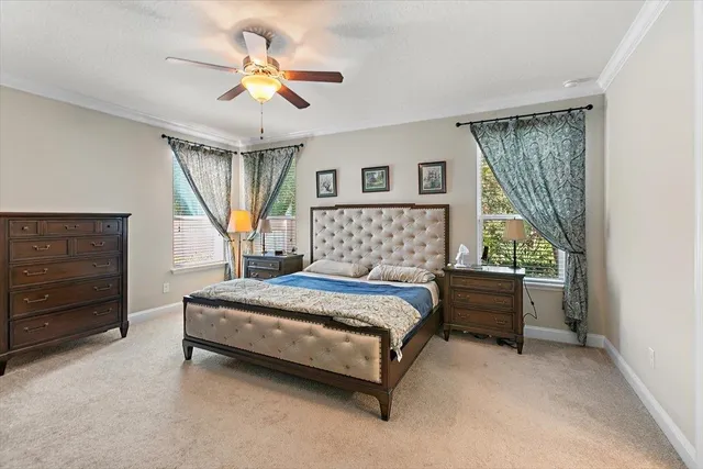 a living room with furniture kitchen view and a chandelier
