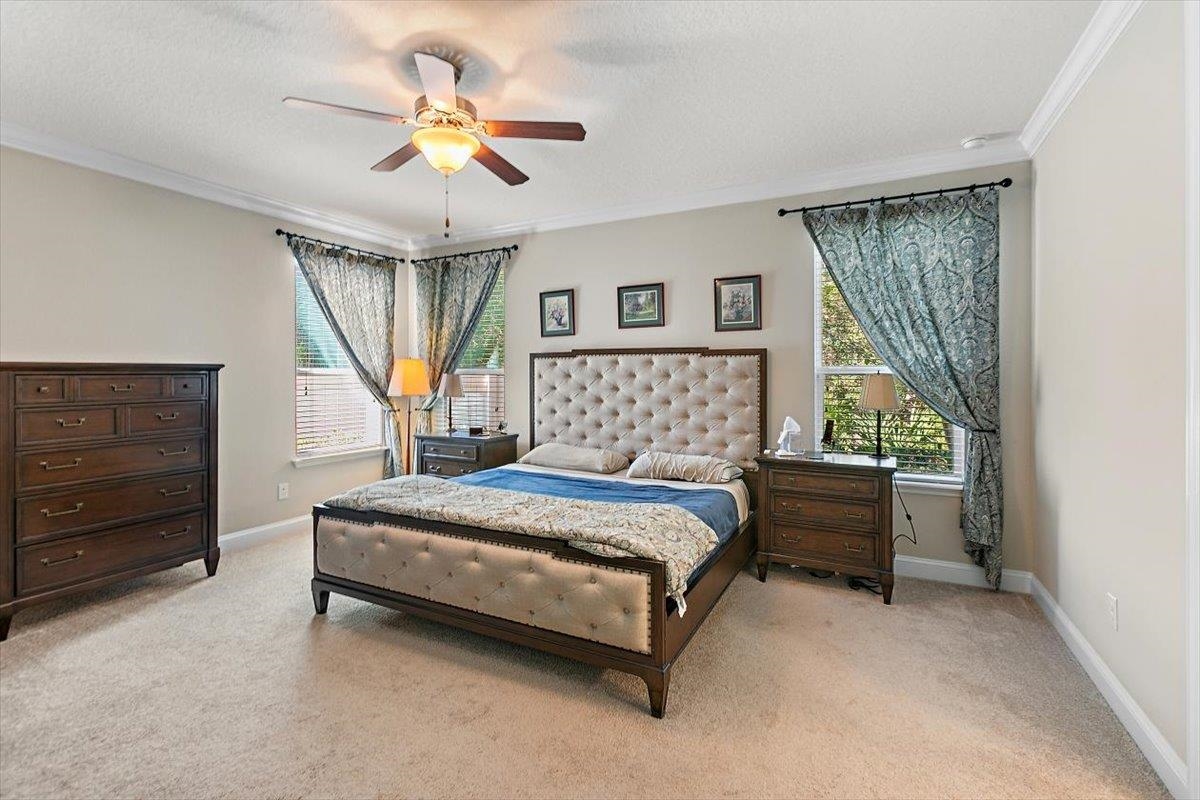 2996 Las Calinas Boulevard St. Augustine, FL 32095 - Photo 14 of 31 a bedroom with a bed and a chandelier