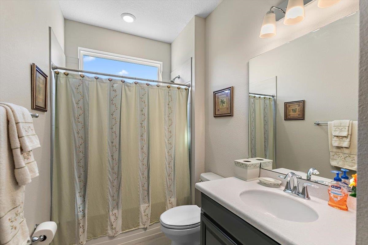 2996 Las Calinas Boulevard St. Augustine, FL 32095 - Photo 18 of 31 a bathroom with a granite countertop sink toilet and shower