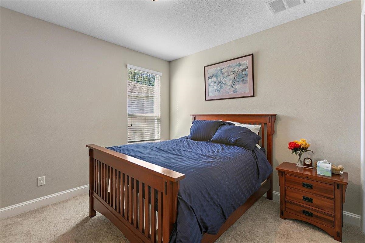 2996 Las Calinas Boulevard St. Augustine, FL 32095 - Photo 19 of 31 a bedroom with bed and paintings on the wall