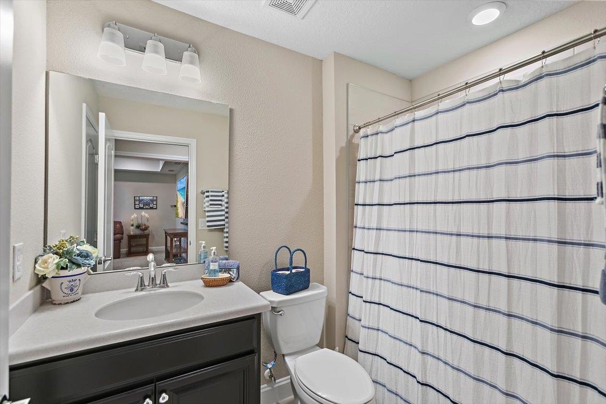 2996 Las Calinas Boulevard St. Augustine, FL 32095 - Photo 24 of 31 a bathroom with a sink mirror vanity and toilet