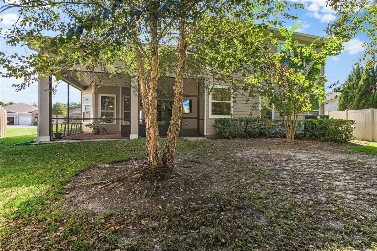 2996 Las Calinas Boulevard St. Augustine, FL 32095 - Photo 27 of 31 a view of a brick house with a big yard and large trees
