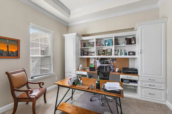 a room with a workspace and a window