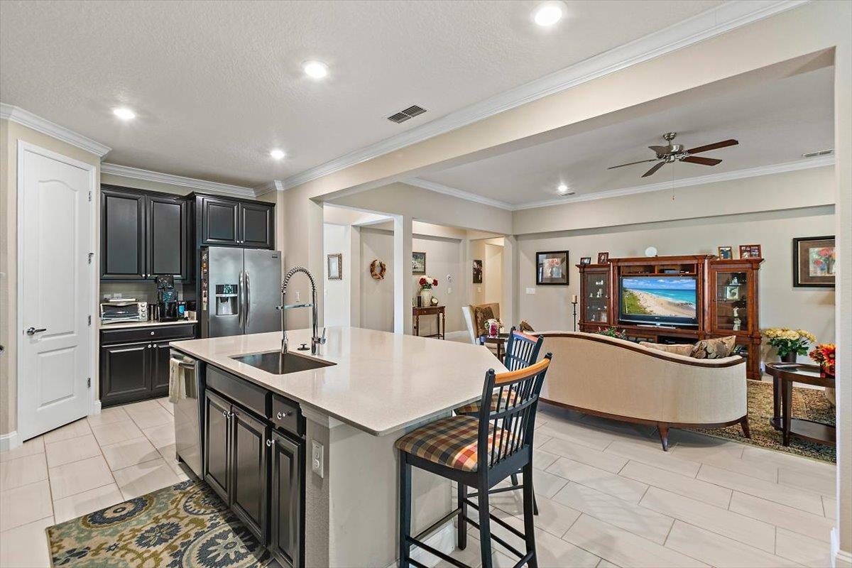 2996 Las Calinas Boulevard St. Augustine, FL 32095 - Photo 31 of 31 a kitchen with stainless steel appliances granite countertop a sink a stove a refrigerator a dining table and chairs