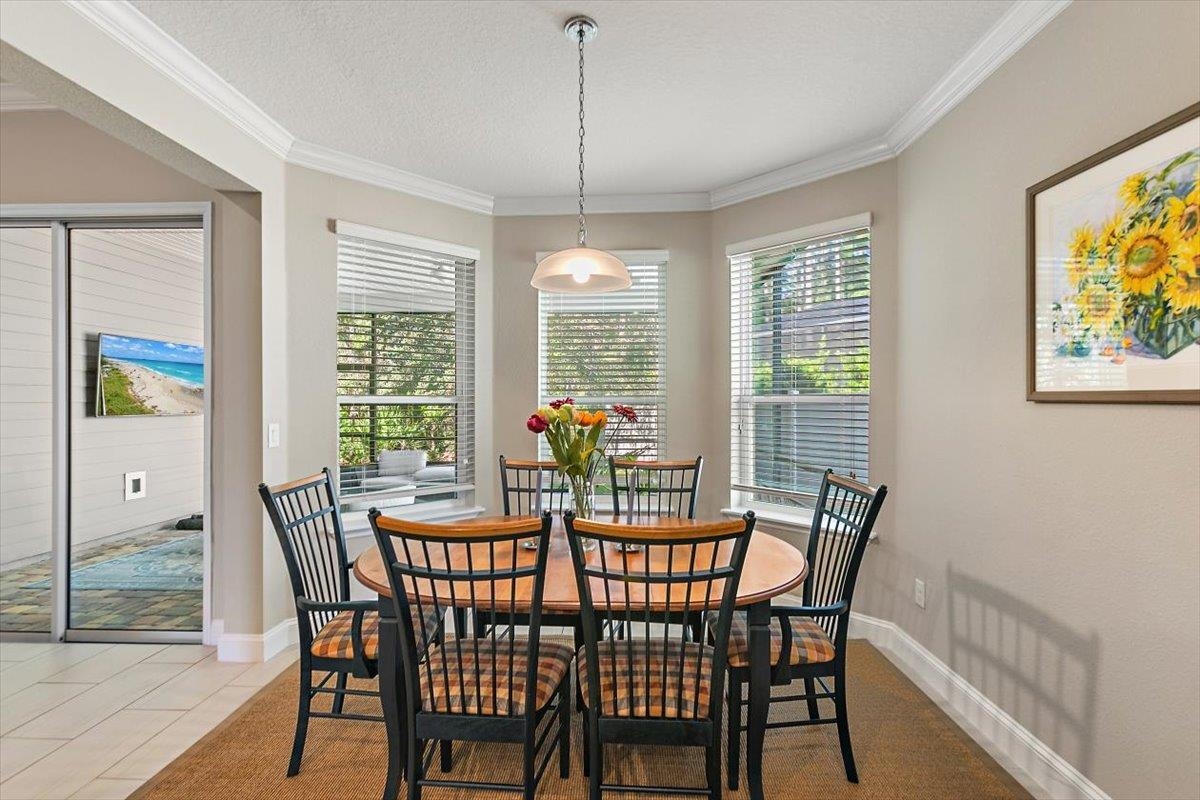2996 Las Calinas Boulevard St. Augustine, FL 32095 - Photo 8 of 31 a view of a dining room with furniture a chandelier and wooden floor