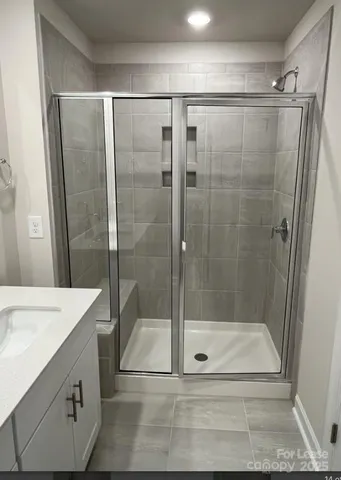 a spacious bathroom with a sink and a mirror