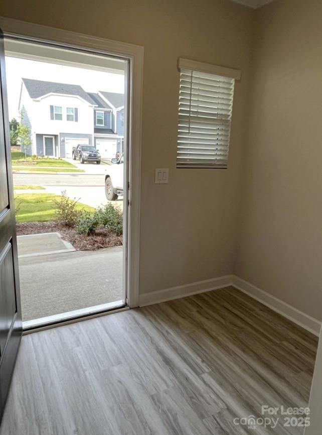 3703 Backwater Street Concord, NC 28027 - Photo 3 of 23 a view of an empty room with wooden floor and a window