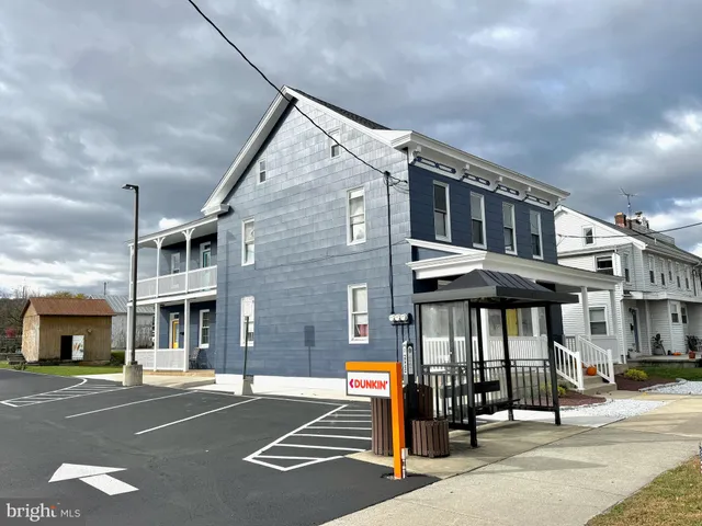 a front view of a building with parking