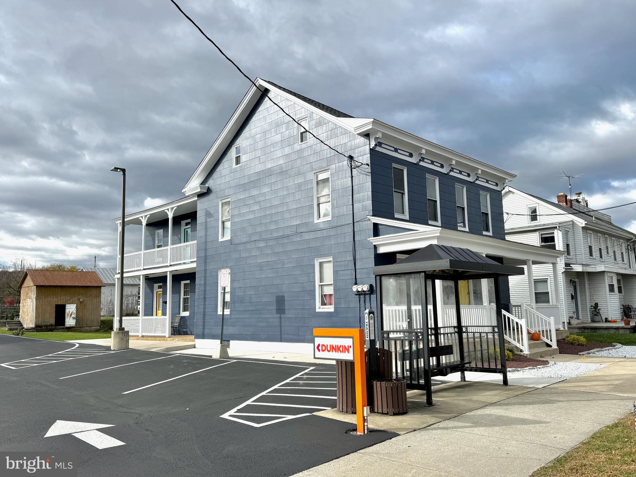 a front view of a building with parking