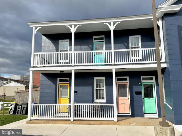 a view of a brick house with large windows