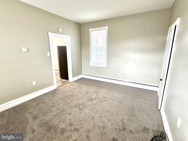 an empty room with windows and entrance