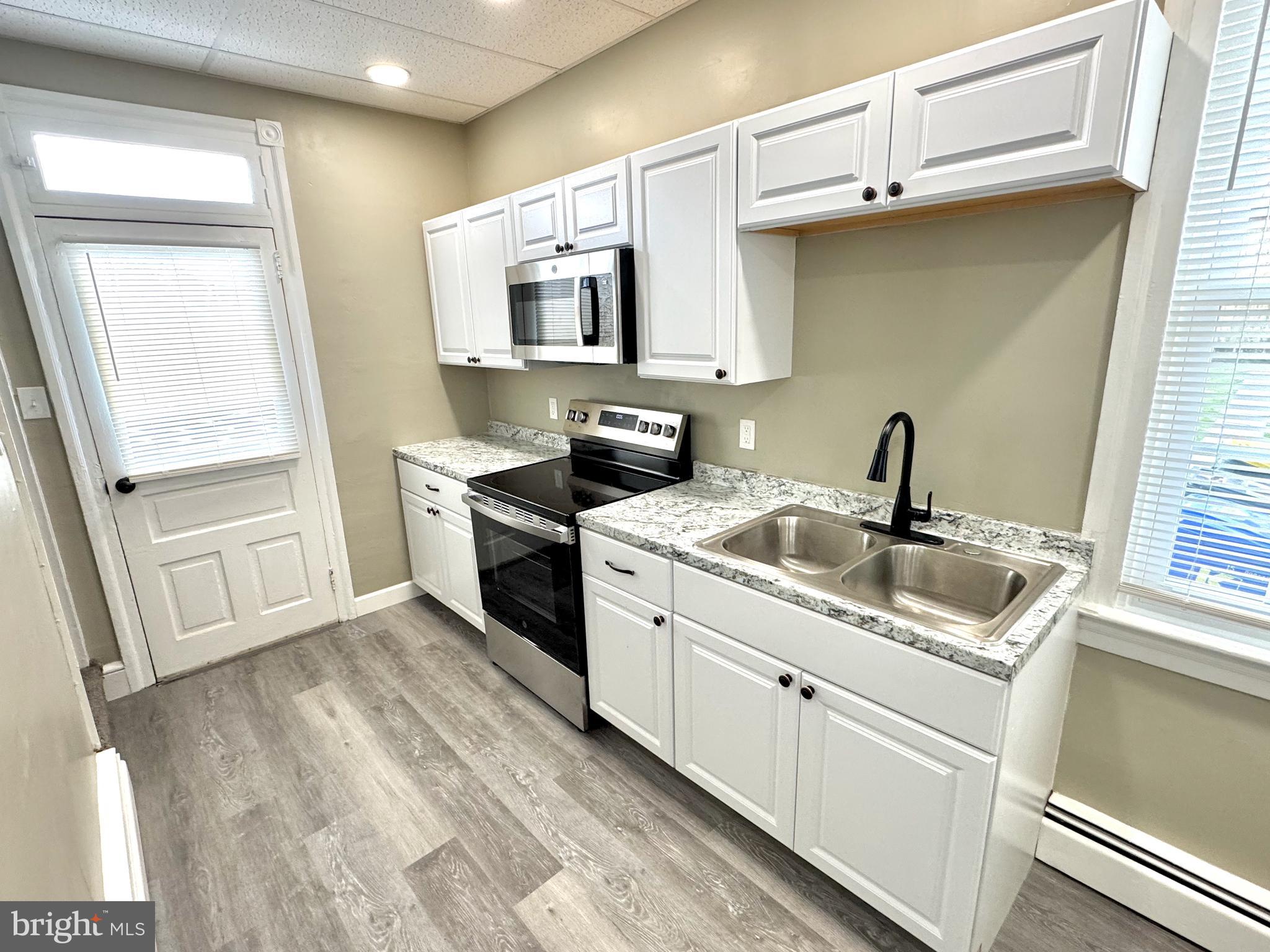 14 West Penn Avenue, Unit 3 Robesonia, PA 19551 - Photo 5 of 13 a kitchen with white cabinets and white appliances