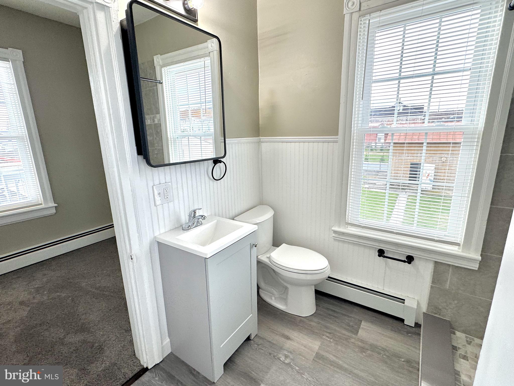 14 West Penn Avenue, Unit 3 Robesonia, PA 19551 - Photo 9 of 13 a bathroom with a toilet sink and mirror