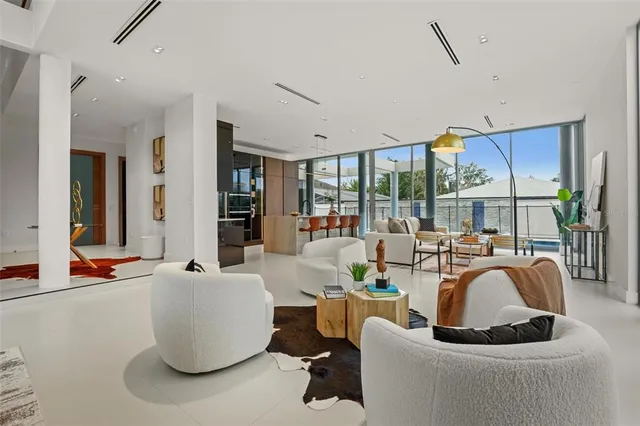 a living room with furniture a window and a potted plant