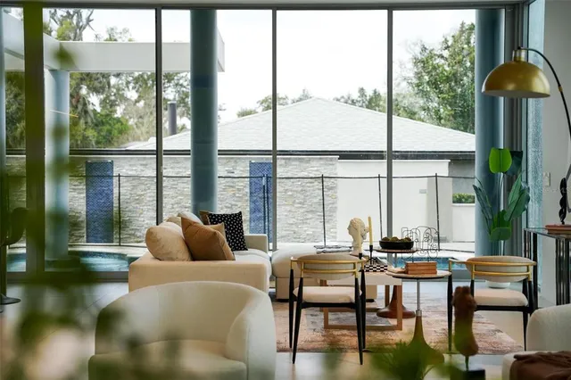 a dining room with furniture and a mirror