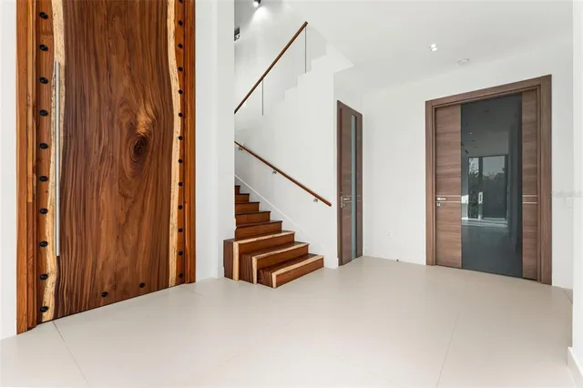 a view of an empty room with a floor to ceiling window and an outdoor view