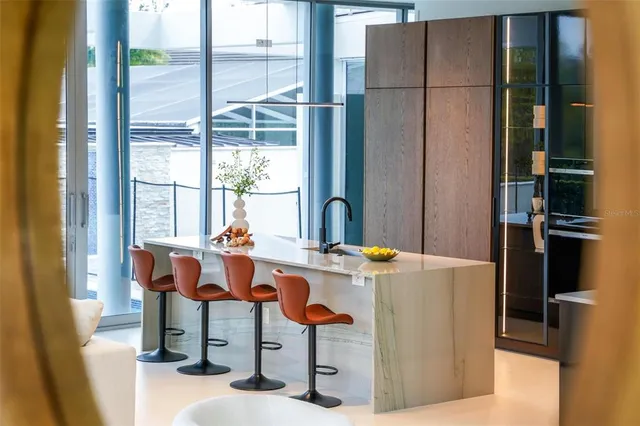 a living room with furniture a window and white walls