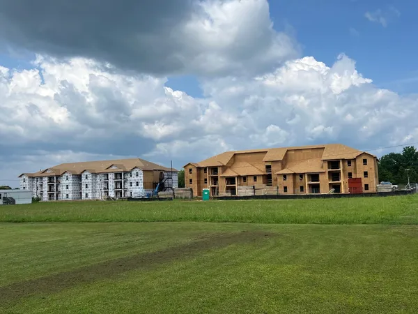 a view of a big yard with a house in the background