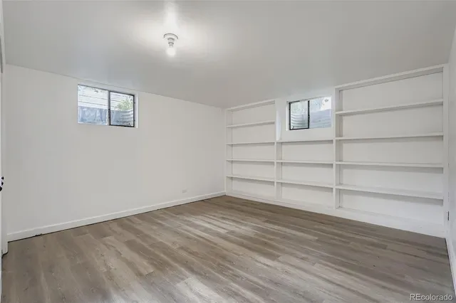 a view of a room with wooden floor and cabinet