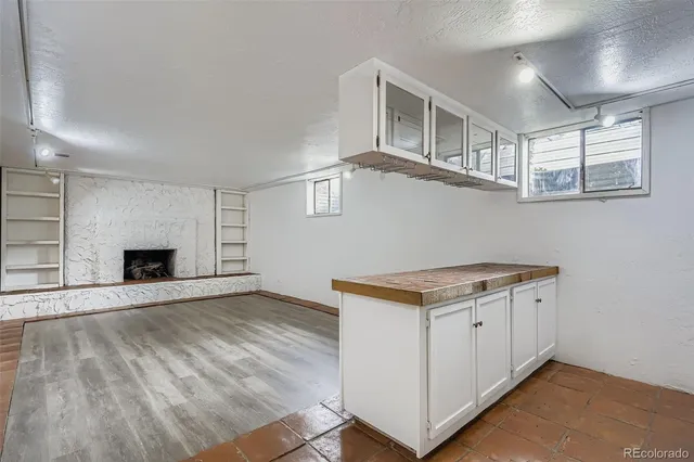 a room with a white cabinets and wooden floor