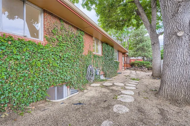 a backyard of a house with shaded area