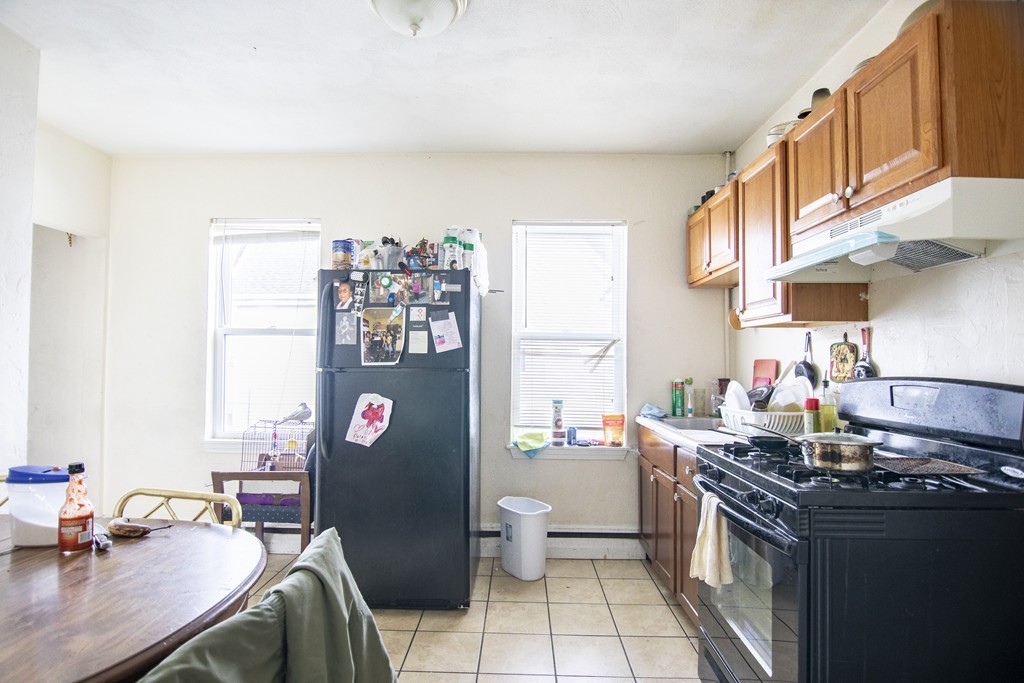 27 Watts Street Chelsea, MA 02150 - Photo 3 of 11 a kitchen with stainless steel appliances a stove a sink and a refrigerator