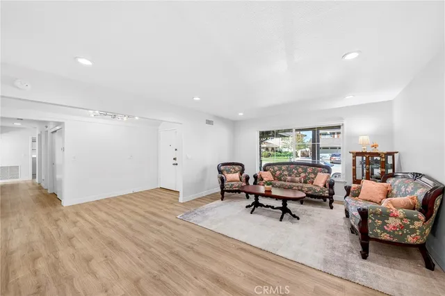 a living room with furniture and a book shelf