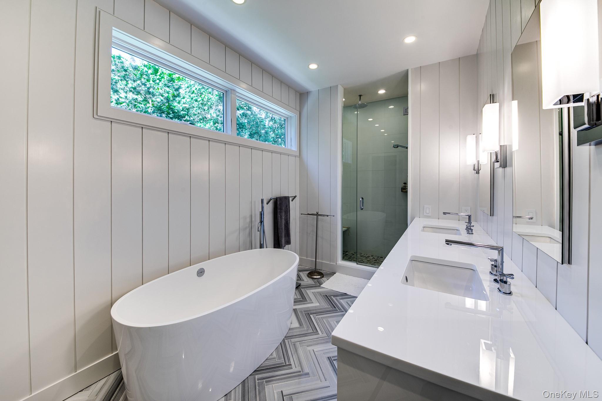 70 Cove Hollow Road East Hampton, NY 11937 - Photo 17 of 21 Full bathroom with a shower stall, a freestanding tub, recessed lighting, and wood walls