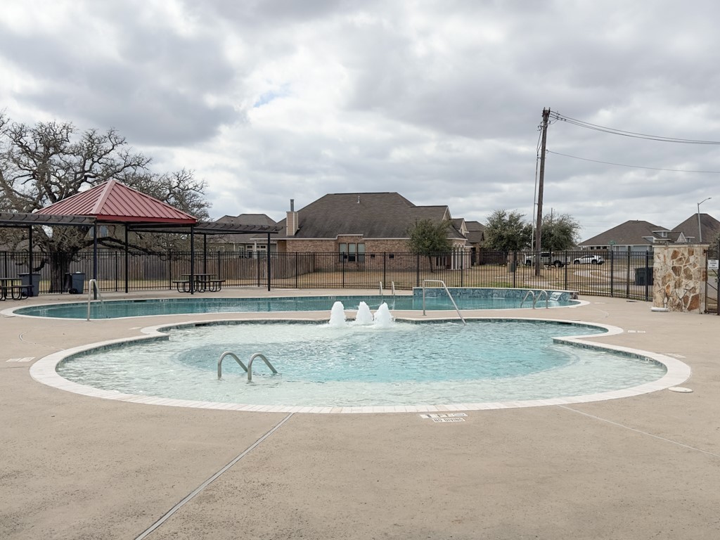 3040 Positano Loop Bryan, TX 77808 - Photo 19 of 20 a view of a swimming pool with a yard