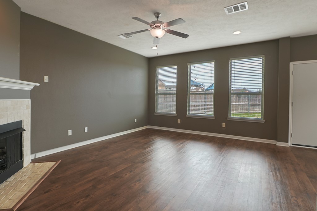 3040 Positano Loop Bryan, TX 77808 - Photo 10 of 20 a view of an empty room with window and wooden floor
