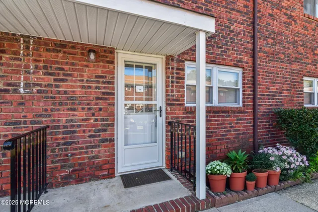 a view of front door of house and outdoor space