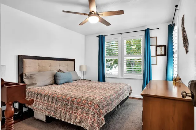 a bedroom with a large bed and a chandelier