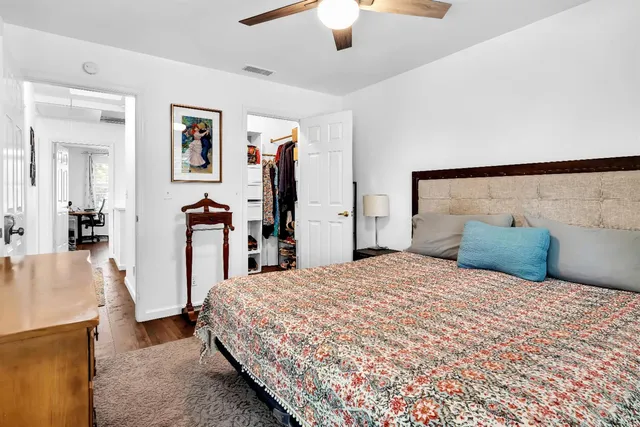 a bedroom with a large bed and a chandelier