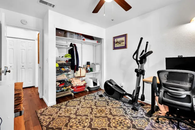 a view of a workspace with furniture and gym equipment