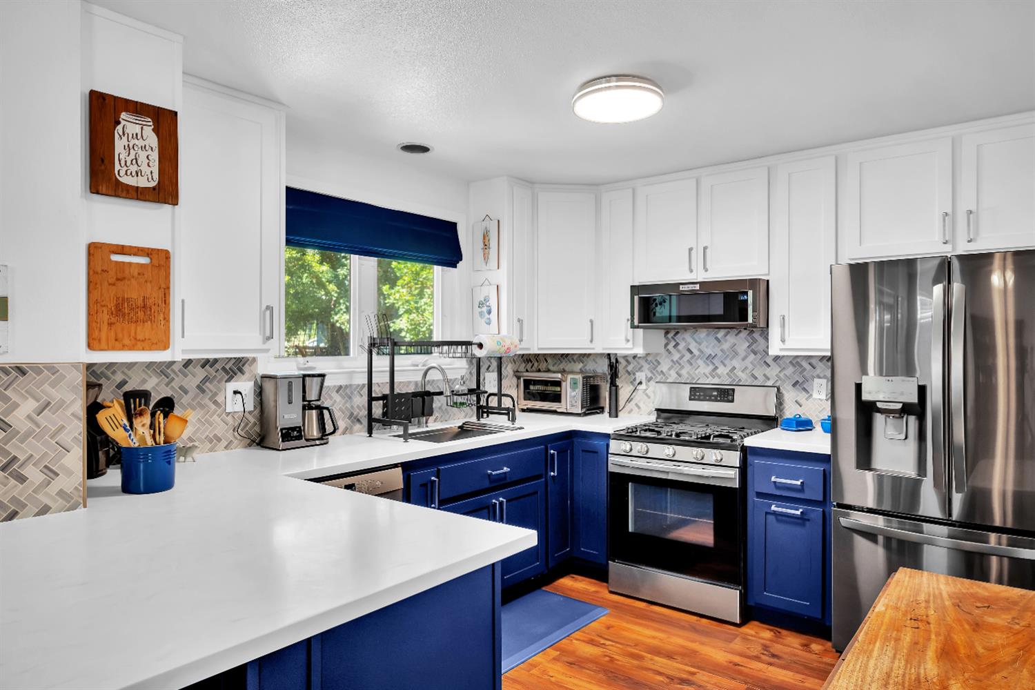 2008 5th Street, Unit 15 Sacramento, CA 95811 - Photo 2 of 49 a kitchen with stainless steel appliances granite countertop a refrigerator a stove a sink dishwasher and white cabinets with wooden floor