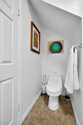 a view of a patio with chairs and potted plants