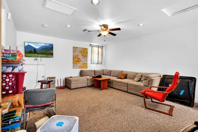 a living room with furniture a couch and a chandelier