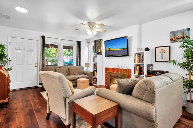 a living room with furniture a fireplace and a flat screen tv