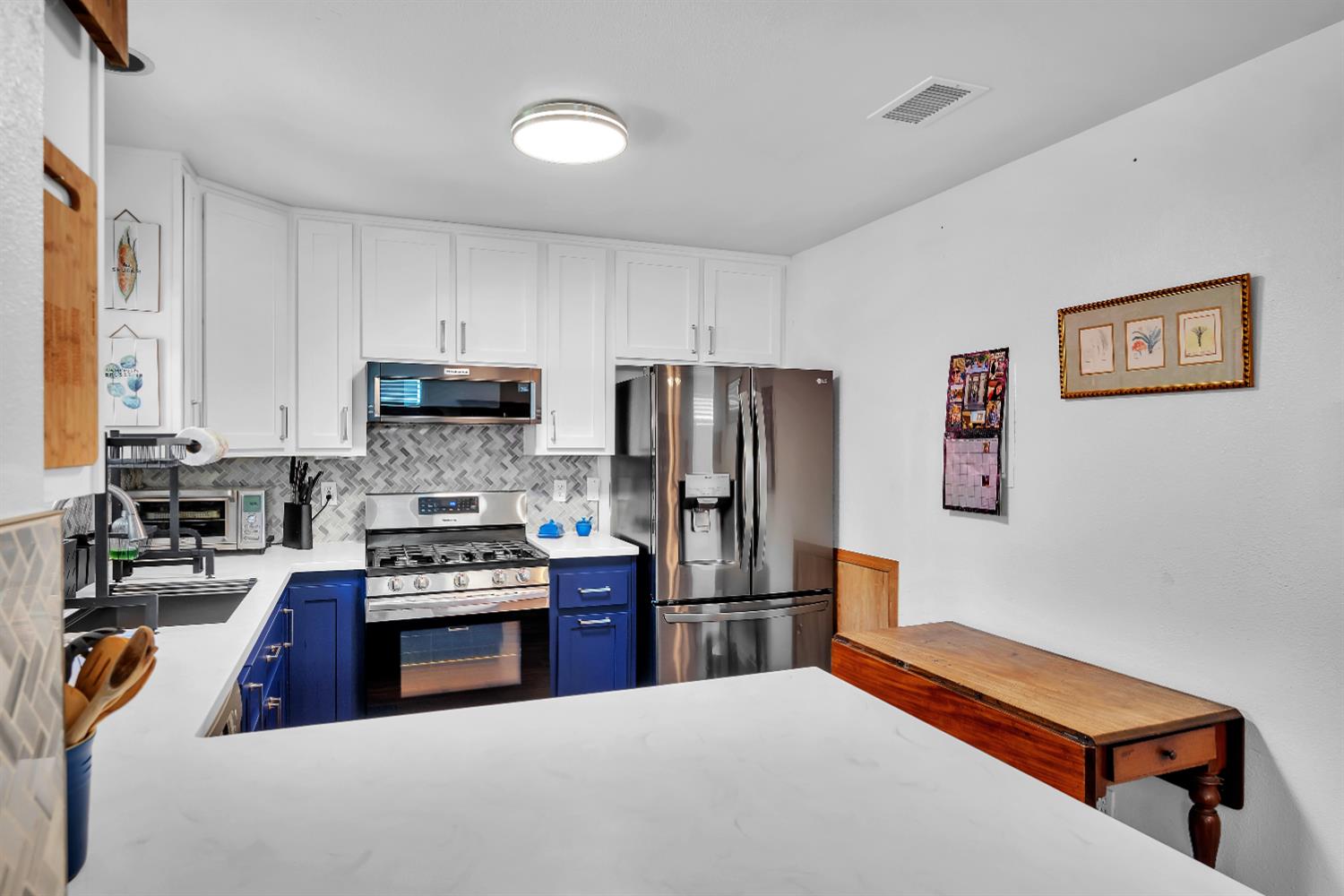 2008 5th Street, Unit 15 Sacramento, CA 95811 - Photo 10 of 49 a kitchen with stainless steel appliances a refrigerator and a stove top oven