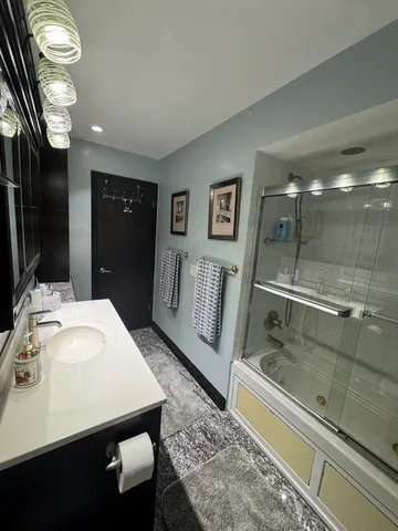 a bathroom with a sink a toilet and mirror