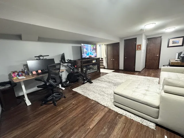 a living room with furniture a flat screen tv and a table