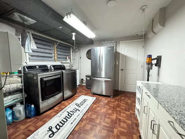a kitchen with granite countertop a stove and a refrigerator
