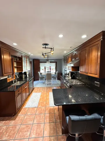 a kitchen with stainless steel appliances granite countertop a sink counter space and a sink