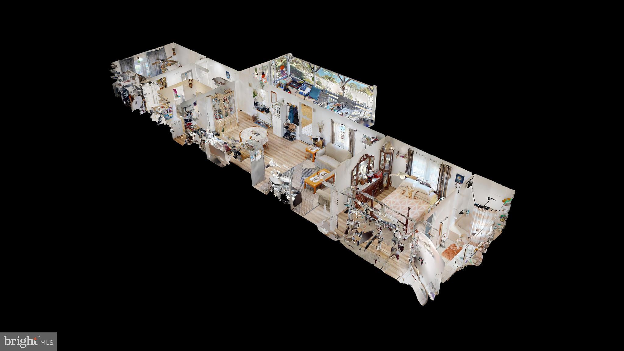 17261 Ridge Line Drive, Unit 18007 Lewes, DE 19958 - Photo 1 of 38 a bed sitting in a bedroom next to a lamp